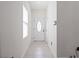 Bright foyer with neutral tile flooring, a white front door, and ample natural light at 2249 Litchfield Loop, Deland, FL 32720