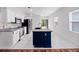 Modern kitchen with a center island, white cabinetry, stainless steel appliances, and a tile backsplash at 2249 Litchfield Loop, Deland, FL 32720