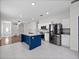 Open kitchen showcasing stainless steel appliances, center island, white cabinetry, and modern lighting at 2249 Litchfield Loop, Deland, FL 32720