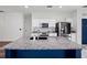 Close-up of kitchen island with granite countertops, modern backsplash, and stainless steel appliances at 2249 Litchfield Loop, Deland, FL 32720
