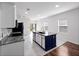 A view of an island kitchen including modern appliances, island seating and open concept layout at 2249 Litchfield Loop, Deland, FL 32720