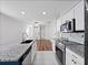 Spacious kitchen with granite countertops, white cabinets, stainless appliances, and an island with sink at 2249 Litchfield Loop, Deland, FL 32720