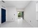 Bright living room with blue pantry door, tile floors, and sliding glass doors to the outdoors at 2249 Litchfield Loop, Deland, FL 32720