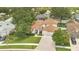 Aerial view of a home with a brown roof, lush green lawn, and two-car garage at 2250 Blossomwood Dr, Oviedo, FL 32765