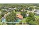 An aerial view of a home with a pool and a fenced in backyard in a lush neighborhood at 2250 Blossomwood Dr, Oviedo, FL 32765