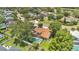 An aerial view of a home with a private pool, fenced yard, and mature trees in a lush neighborhood at 2250 Blossomwood Dr, Oviedo, FL 32765