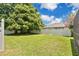 Spacious backyard with green grass and a white fence around the perimeter of the property at 2250 Blossomwood Dr, Oviedo, FL 32765