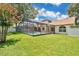 Enjoy the privacy of the screened-in pool and large grassy backyard, perfect for relaxation at 2250 Blossomwood Dr, Oviedo, FL 32765