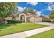 Charming home with a well-manicured lawn, inviting entryway, and attached two-car garage at 2250 Blossomwood Dr, Oviedo, FL 32765