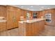 Spacious kitchen featuring custom wooden cabinets, stainless steel appliances, and a large center island at 2250 Blossomwood Dr, Oviedo, FL 32765