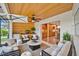 Inviting screened lanai with comfortable seating, a ceiling fan, and views of the kitchen at 2250 Blossomwood Dr, Oviedo, FL 32765