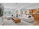 Open-concept living room with large windows and integrated kitchen, offering ample space for relaxation and gatherings at 2250 Blossomwood Dr, Oviedo, FL 32765