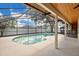 Screened-in pool with white concrete patio and outdoor lounge area at 2250 Blossomwood Dr, Oviedo, FL 32765