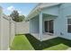 Backyard featuring artificial turf, a fence, and a covered patio with a sliding glass door at 2337 Bexley Pl, Casselberry, FL 32707