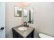 This bathroom features an undermount sink with stone countertop, and a large decorative mirror at 2337 Bexley Pl, Casselberry, FL 32707