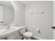 Half bathroom featuring a pedestal sink and toilet with modern fixtures and paint at 2337 Bexley Pl, Casselberry, FL 32707