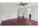 Large bedroom featuring hardwood floors, ceiling fan, and an ensuite bathroom at 2337 Bexley Pl, Casselberry, FL 32707