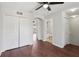 Bedroom showcasing hardwood floors, a ceiling fan, closet, and an en-suite bathroom at 2337 Bexley Pl, Casselberry, FL 32707