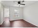Cozy bedroom featuring hardwood floors, a ceiling fan, and a window with a neighborhood view at 2337 Bexley Pl, Casselberry, FL 32707