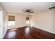 Well-lit bedroom features hardwood floors, ceiling fan and two windows at 2337 Bexley Pl, Casselberry, FL 32707
