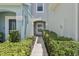 Pathway to the front entrance is lined with lush hedges and manicured landscaping at 2337 Bexley Pl, Casselberry, FL 32707