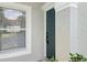 Close-up view of the front door and window, showcasing curb appeal at 2337 Bexley Pl, Casselberry, FL 32707