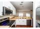 Modern kitchen features stainless steel appliances, white cabinets, and hardwood floors at 2337 Bexley Pl, Casselberry, FL 32707
