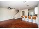 Open-concept living room boasts hardwood floors, a ceiling fan, and a breakfast bar with seating at 2337 Bexley Pl, Casselberry, FL 32707