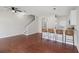 Open-concept living area with hardwood floors, stairs, and a breakfast bar with seating at 2337 Bexley Pl, Casselberry, FL 32707
