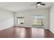 Bright living room with hardwood floors, ceiling fan, and sliding glass door to the patio at 2337 Bexley Pl, Casselberry, FL 32707