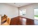 Spacious living room featuring hardwood floors and ample natural light from a window and sliding glass door at 2337 Bexley Pl, Casselberry, FL 32707