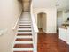 Staircase features hardwood flooring and white railings, leading to the upper level of the home at 2337 Bexley Pl, Casselberry, FL 32707