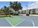 Well-maintained basketball court with green and blue surface and fenced perimeter at 2409 Silver Palm Dr, Kissimmee, FL 34747