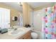 The bathroom features a tub and shower, a toilet, and a sink and vanity with a mirror above at 2409 Silver Palm Dr, Kissimmee, FL 34747