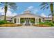 Elegant clubhouse with manicured landscaping and a welcoming entrance framed by palm trees at 2409 Silver Palm Dr, Kissimmee, FL 34747