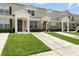 Two-story townhome featuring a well-manicured lawn at 2409 Silver Palm Dr, Kissimmee, FL 34747