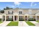 Inviting townhome featuring a well-manicured lawn and charming architectural details at 2409 Silver Palm Dr, Kissimmee, FL 34747