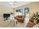 Comfortable living room with a sliding glass door leading to the outdoor area at 2409 Silver Palm Dr, Kissimmee, FL 34747