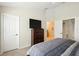 Comfortable bedroom featuring neutral paint, carpet floors, and access to the en-suite bathroom at 2409 Silver Palm Dr, Kissimmee, FL 34747