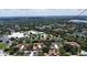 Aerial view of townhomes neighborhood near commercial buildings and a lake at 271 Raintree Dr, Casselberry, FL 32707