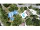 Aerial view featuring tennis and pickleball courts and pool with ample green space and landscaping at 271 Raintree Dr, Casselberry, FL 32707