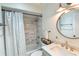 Updated bathroom with modern fixtures, a tiled shower, and a stylish round mirror at 271 Raintree Dr, Casselberry, FL 32707
