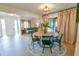 Open-concept dining room with a round table, stylish rug, and adjacent living area at 271 Raintree Dr, Casselberry, FL 32707