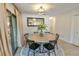 Bright dining room featuring a round table, black chairs, and a modern light fixture at 271 Raintree Dr, Casselberry, FL 32707
