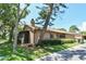 A charming single-story home with mature trees, lush landscaping, and a well-kept lawn at 271 Raintree Dr, Casselberry, FL 32707
