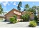 Charming home featuring an attached garage, lush greenery, and well-maintained landscaping at 271 Raintree Dr, Casselberry, FL 32707