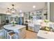 Updated kitchen with marble countertops, stainless appliances, modern pendant lights, and open flow into living areas at 271 Raintree Dr, Casselberry, FL 32707