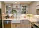 Farmhouse sink with stainless appliances and open shelving create a modern kitchen look at 271 Raintree Dr, Casselberry, FL 32707