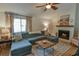 Comfortable living room boasting a fireplace, ceiling fan and views of the front yard at 271 Raintree Dr, Casselberry, FL 32707
