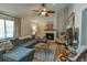 Cozy living room showcasing a fireplace, ceiling fan and lots of natural light at 271 Raintree Dr, Casselberry, FL 32707